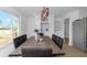 Bright dining room features modern light fixture, sleek furniture and built-in bar area for entertaining at 6508 Senegal Palm Way, Apollo Beach, FL 33572