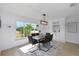 This dining room offers a unique modern light fixture and a lovely view of the outdoors at 6508 Senegal Palm Way, Apollo Beach, FL 33572