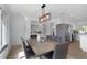 Well-lit dining room with open concept kitchen featuring stainless steel appliances and island at 6508 Senegal Palm Way, Apollo Beach, FL 33572