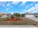 Charming single-story home with well-maintained landscaping including decorative stone and palm trees at 6508 Senegal Palm Way, Apollo Beach, FL 33572