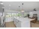 Bright, open kitchen features an island with bar seating and ample lighting at 6508 Senegal Palm Way, Apollo Beach, FL 33572