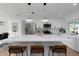 Open concept kitchen features a large island, modern pendant lights and stainless appliances at 6508 Senegal Palm Way, Apollo Beach, FL 33572