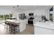 Open floor plan with a large kitchen island, stainless appliances, and modern accents at 6508 Senegal Palm Way, Apollo Beach, FL 33572