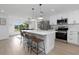 Spacious open kitchen with island seating, stainless appliances, and an open concept design at 6508 Senegal Palm Way, Apollo Beach, FL 33572
