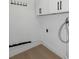 Functional laundry area featuring white cabinets and utility connections for convenience at 6508 Senegal Palm Way, Apollo Beach, FL 33572