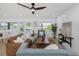 Spacious open-concept living room flows to the kitchen with island seating and an outdoor pool view at 6508 Senegal Palm Way, Apollo Beach, FL 33572