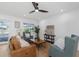 Comfortable living area open to the pool deck and kitchen, with lots of natural light and a ceiling fan at 6508 Senegal Palm Way, Apollo Beach, FL 33572