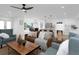 Comfortable living room with ceiling fan, open concept to kitchen and dining area at 6508 Senegal Palm Way, Apollo Beach, FL 33572
