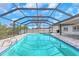 Backyard pool area enclosed with screen, offering privacy and sun protection at 6508 Senegal Palm Way, Apollo Beach, FL 33572