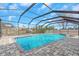 Screened-in pool with brick patio and in-ground spa offers a luxurious outdoor living space at 6508 Senegal Palm Way, Apollo Beach, FL 33572