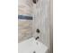 Bathroom shower with sleek gray subway tile, glass doors, and modern fixtures at 6508 Senegal Palm Way, Apollo Beach, FL 33572