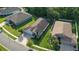 Aerial view features a well-maintained home with lush landscaping and large driveway at 6555 Sparkling Way, Wesley Chapel, FL 33545