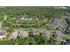 An aerial view of a community featuring ponds, lush trees, and a community pool at 6555 Sparkling Way, Wesley Chapel, FL 33545