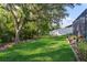 Spacious fenced backyard with mature landscaping for privacy and enjoyment at 6555 Sparkling Way, Wesley Chapel, FL 33545