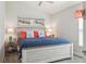 Charming bedroom featuring a beachy theme with coastal decor and light-colored furniture at 6555 Sparkling Way, Wesley Chapel, FL 33545