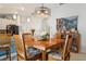 Inviting dining room features a modern light fixture and charming decor at 6555 Sparkling Way, Wesley Chapel, FL 33545