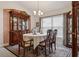 Elegant dining room featuring a classic chandelier, seating for six, and ornate china cabinet at 6555 Sparkling Way, Wesley Chapel, FL 33545