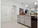 Open kitchen showcasing gray cabinets, granite counters, and modern appliances at 6555 Sparkling Way, Wesley Chapel, FL 33545