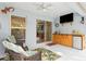 Entertain on the lanai with mounted TV, ceiling fan, and convenient built-in bar area at 6555 Sparkling Way, Wesley Chapel, FL 33545