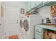 Functional laundry room with modern washer and dryer units and ample storage space at 6555 Sparkling Way, Wesley Chapel, FL 33545