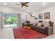 Cozy living room boasts sliding doors to the backyard, with neutral colors and decor at 6555 Sparkling Way, Wesley Chapel, FL 33545