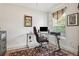 Cozy home office space featuring a glass desk, comfortable chair, and a view to the outside at 6555 Sparkling Way, Wesley Chapel, FL 33545