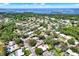 Aerial view of the property nestled in a lush, green neighborhood with waterfront views, emphasizing its prime location at 7092 119Th St, Seminole, FL 33772