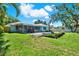 Expansive backyard features a refreshing in-ground pool and covered patio, ideal for outdoor relaxation and entertainment at 7092 119Th St, Seminole, FL 33772
