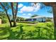 Lush backyard with mature trees and landscaping, providing a serene and private outdoor space at 7092 119Th St, Seminole, FL 33772