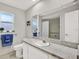 Bathroom featuring a marble countertop, white vanity, and a window with natural light at 7092 119Th St, Seminole, FL 33772