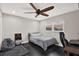 Bedroom with dark floors, a ceiling fan, a bed, and a workspace at 7092 119Th St, Seminole, FL 33772