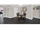 Cozy dining area with seating for four, a decorative clock, and seamless access to other rooms at 7092 119Th St, Seminole, FL 33772