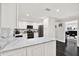 Bright kitchen featuring white cabinetry, marble backsplash, stainless appliances and sleek countertops at 7092 119Th St, Seminole, FL 33772