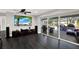 Bright living room featuring sleek dark flooring, a ceiling fan, and seamless access to the outdoor patio at 7092 119Th St, Seminole, FL 33772