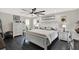 Serene main bedroom with a ceiling fan, natural light, and a king-sized bed with white linens at 7092 119Th St, Seminole, FL 33772