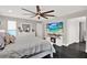 Spacious main bedroom featuring a ceiling fan, TV, and modern decor at 7092 119Th St, Seminole, FL 33772