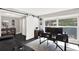 Home office with a large window, barn door, modern desk and gray rug at 7092 119Th St, Seminole, FL 33772