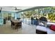 Spacious screened-in porch features a dining area and comfortable lounge seating, ideal for entertaining guests at 7092 119Th St, Seminole, FL 33772