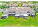 Aerial view of a townhouse backyard with lawn, screened patio, and exterior storage at 727 Kensington Lake Cir, Brandon, FL 33511