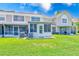 The backyard has a spacious lawn and screened in porch at 727 Kensington Lake Cir, Brandon, FL 33511