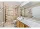 Bathroom featuring neutral tile walls, shower, toilet, and vanity with white countertop at 727 Kensington Lake Cir, Brandon, FL 33511
