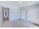 A carpeted bedroom has a double door closet and white trim at 727 Kensington Lake Cir, Brandon, FL 33511