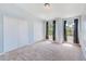 Carpeted bedroom with two windows, and a double door closet at 727 Kensington Lake Cir, Brandon, FL 33511