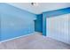 Carpeted bedroom with a large closet and light blue painted walls at 727 Kensington Lake Cir, Brandon, FL 33511