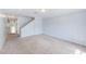 Spacious living room with carpet floors, neutral paint and stairs leading to the upper level at 727 Kensington Lake Cir, Brandon, FL 33511