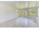 Spacious, bright sunroom with tile flooring and multiple windows with a view of the backyard at 727 Kensington Lake Cir, Brandon, FL 33511