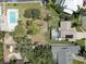 Birds-eye view of the property, featuring a screened-in pool and surrounding greenery in a quiet neighborhood at 7600 Drew Oak Dr, Seminole, FL 33772