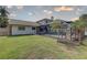 Beautiful backyard with a screened-in pool, well-maintained lawn, and lush landscaping offering privacy at 7600 Drew Oak Dr, Seminole, FL 33772