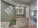 Tasteful bathroom with granite countertops, white cabinets, wood-look tile floors, and a large vanity at 7600 Drew Oak Dr, Seminole, FL 33772