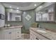 Spacious bathroom showcasing dual granite-topped vanities, a tile floor, and ample lighting at 7600 Drew Oak Dr, Seminole, FL 33772